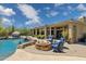 Spacious backyard featuring a cozy fire pit and seating around the pristine pool with rock features at 22469 N 79Th Pl, Scottsdale, AZ 85255