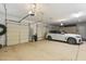 Large garage with parking for one car, three garage doors, and plenty of storage space at 22469 N 79Th Pl, Scottsdale, AZ 85255