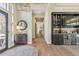 Inviting hallway with hardwood floors, built-in bar, and custom lighting fixture at 22469 N 79Th Pl, Scottsdale, AZ 85255