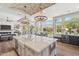 Entertainer's kitchen with large island, bar seating, high-end appliances, and backyard views at 22469 N 79Th Pl, Scottsdale, AZ 85255