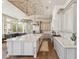 Gourmet kitchen featuring a large marble island, stainless steel appliances, and brick ceiling detail at 22469 N 79Th Pl, Scottsdale, AZ 85255
