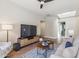 Open-concept living room with hardwood floors, modern TV, and recessed lighting at 22469 N 79Th Pl, Scottsdale, AZ 85255