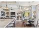 Open concept living room with fireplace, shelving, chandeliers, island with seating, and backyard views at 22469 N 79Th Pl, Scottsdale, AZ 85255