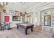 Spacious living room featuring a pool table, hardwood floors, and stylish lighting at 22469 N 79Th Pl, Scottsdale, AZ 85255