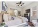 Main bedroom with sliding barn door to bathroom, hardwood floors, and ceiling fan at 22469 N 79Th Pl, Scottsdale, AZ 85255