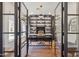 Beautiful home office with custom built-in bookshelves, statement lighting, and glass paneled doors at 22469 N 79Th Pl, Scottsdale, AZ 85255