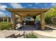 Inviting outdoor kitchen with a bar, grill, ceiling fan, and steps leading to a beautiful backyard at 22469 N 79Th Pl, Scottsdale, AZ 85255