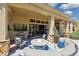 Stylish patio featuring a cozy seating area around a fire pit and an outdoor television at 22469 N 79Th Pl, Scottsdale, AZ 85255