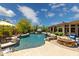 Lush backyard featuring a large pool, water features, a cozy fire pit, and manicured landscaping at 22469 N 79Th Pl, Scottsdale, AZ 85255