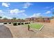 A spacious, low-maintenance backyard with artificial turf, patio seating, and desert landscaping at 22825 E Mewes Rd, Queen Creek, AZ 85142