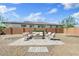 Cozy backyard featuring an outdoor fire pit, comfortable seating, and serene ambiance at 22825 E Mewes Rd, Queen Creek, AZ 85142