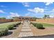 Expansive backyard featuring lush landscaping, paved pathway, and outdoor seating area at 22825 E Mewes Rd, Queen Creek, AZ 85142