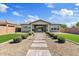Well-manicured backyard with paver path, lush green lawns, and view of the home's rear elevation at 22825 E Mewes Rd, Queen Creek, AZ 85142