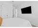 Bright bedroom with clean white walls, white bedding, and a large television at 22825 E Mewes Rd, Queen Creek, AZ 85142