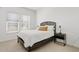 Cozy bedroom with neutral tones, a queen bed, and a modern nightstand with a lamp at 22825 E Mewes Rd, Queen Creek, AZ 85142