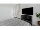 Bedroom with large television, modern furniture, and ample natural light at 22825 E Mewes Rd, Queen Creek, AZ 85142