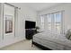 Bright, airy bedroom featuring a large window, modern furniture, and ample natural light at 22825 E Mewes Rd, Queen Creek, AZ 85142