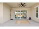 Covered patio with ceiling fan, sliding glass doors, and a view of the landscaped backyard at 22825 E Mewes Rd, Queen Creek, AZ 85142
