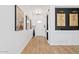 Inviting entryway with wood flooring, white walls, and decorative artwork at 22825 E Mewes Rd, Queen Creek, AZ 85142