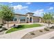 Well-maintained home exterior with manicured landscaping, a paved driveway, and a two-car garage at 22825 E Mewes Rd, Queen Creek, AZ 85142