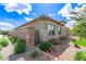 View of the home's side, showcasing the decorative landscaping and stonework at 22825 E Mewes Rd, Queen Creek, AZ 85142
