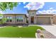 Beautiful single-story home featuring a manicured lawn and desert landscaping with a neutral color palette at 22825 E Mewes Rd, Queen Creek, AZ 85142