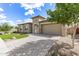 A single story home with lush green grass, decorative trees, and a paved driveway at 22825 E Mewes Rd, Queen Creek, AZ 85142