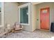 A charming front porch with a seating area, a small table, and a view of the front yard at 22825 E Mewes Rd, Queen Creek, AZ 85142