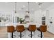 Modern kitchen with a large island, stainless steel appliances, and pendant lighting above breakfast bar seating at 22825 E Mewes Rd, Queen Creek, AZ 85142