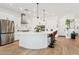 Bright, open kitchen with stainless steel appliances, quartz countertops, and an oversized breakfast bar at 22825 E Mewes Rd, Queen Creek, AZ 85142
