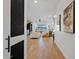 Bright open-concept living room featuring a light color palette, wood floors, and contemporary decor at 22825 E Mewes Rd, Queen Creek, AZ 85142