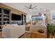 Bright living room featuring a stylish entertainment center and sliding glass doors to backyard at 22825 E Mewes Rd, Queen Creek, AZ 85142