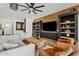 Stylish living room with built-in shelving, a ceiling fan, and comfortable seating at 22825 E Mewes Rd, Queen Creek, AZ 85142