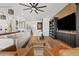 Stylish living room with built-in shelving, ceiling fan, and modern furniture at 22825 E Mewes Rd, Queen Creek, AZ 85142