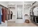 Spacious walk-in closet featuring custom shelving and hanging racks for organized storage at 22825 E Mewes Rd, Queen Creek, AZ 85142