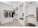 Bright walk-in closet with custom shelving and storage space; features an entry to an en-suite bath at 22825 E Mewes Rd, Queen Creek, AZ 85142