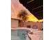 Backyard pool area featuring a storage shed and a colorful sunset at 2459 E Baltimore St, Mesa, AZ 85213