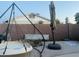 A backyard featuring a hanging egg chair, patio umbrella, and brick wall fence at 2459 E Baltimore St, Mesa, AZ 85213