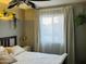 Bright bedroom with a large window and neutral colors, featuring decoratives plants at 2459 E Baltimore St, Mesa, AZ 85213