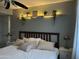Cozy bedroom featuring neutral tones, decorative shelf, and large bed with comfortable pillows at 2459 E Baltimore St, Mesa, AZ 85213