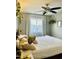 Bedroom featuring a large window with sheer curtains and a ceiling fan at 2459 E Baltimore St, Mesa, AZ 85213