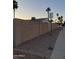 Residential exterior showcasing block wall, gravel yard, and a clear sky during golden hour at 2459 E Baltimore St, Mesa, AZ 85213