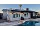 Charming backyard featuring a pristine pool, covered patio, and lush landscaping for outdoor enjoyment at 2459 E Baltimore St, Mesa, AZ 85213