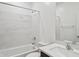 A clean bathroom contains a tub, shower, toilet, sink and mirror surrounded by white and grey marble at 25473 W Graham Trl, Buckeye, AZ 85326
