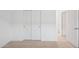 This carpeted bedroom has a double door closet and a bedroom door and is painted white at 25473 W Graham Trl, Buckeye, AZ 85326