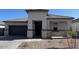 Charming single-story home with a covered porch, neutral palette, and well-manicured front yard at 25473 W Graham Trl, Buckeye, AZ 85326