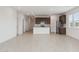 Modern kitchen open to the living area, featuring an island, stainless appliances, and ample cabinet space at 25473 W Graham Trl, Buckeye, AZ 85326