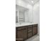 Bright bathroom featuring double sinks, a large mirror, and shaker cabinets with neutral finishes at 25479 W Graham Trl, Buckeye, AZ 85326