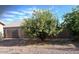 The backyard boasts gravel and lush trees at 2618 S 81St Ln, Phoenix, AZ 85043