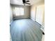 Cozy bedroom with a ceiling fan, a window for natural light, and a closet with sliding doors at 2618 S 81St Ln, Phoenix, AZ 85043